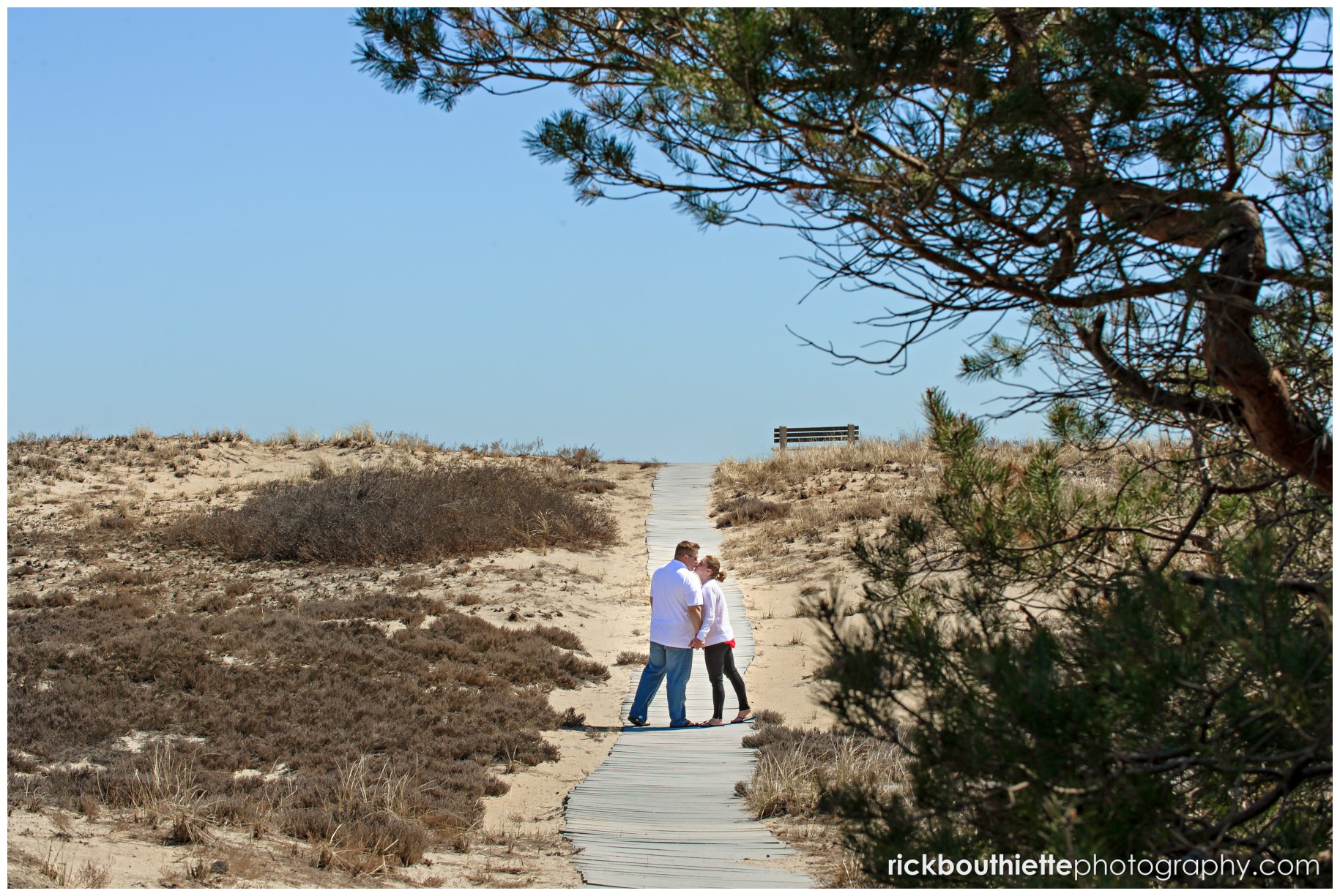 couple walking on boardwalk, NH engagement photography at New Hampshire seacoast