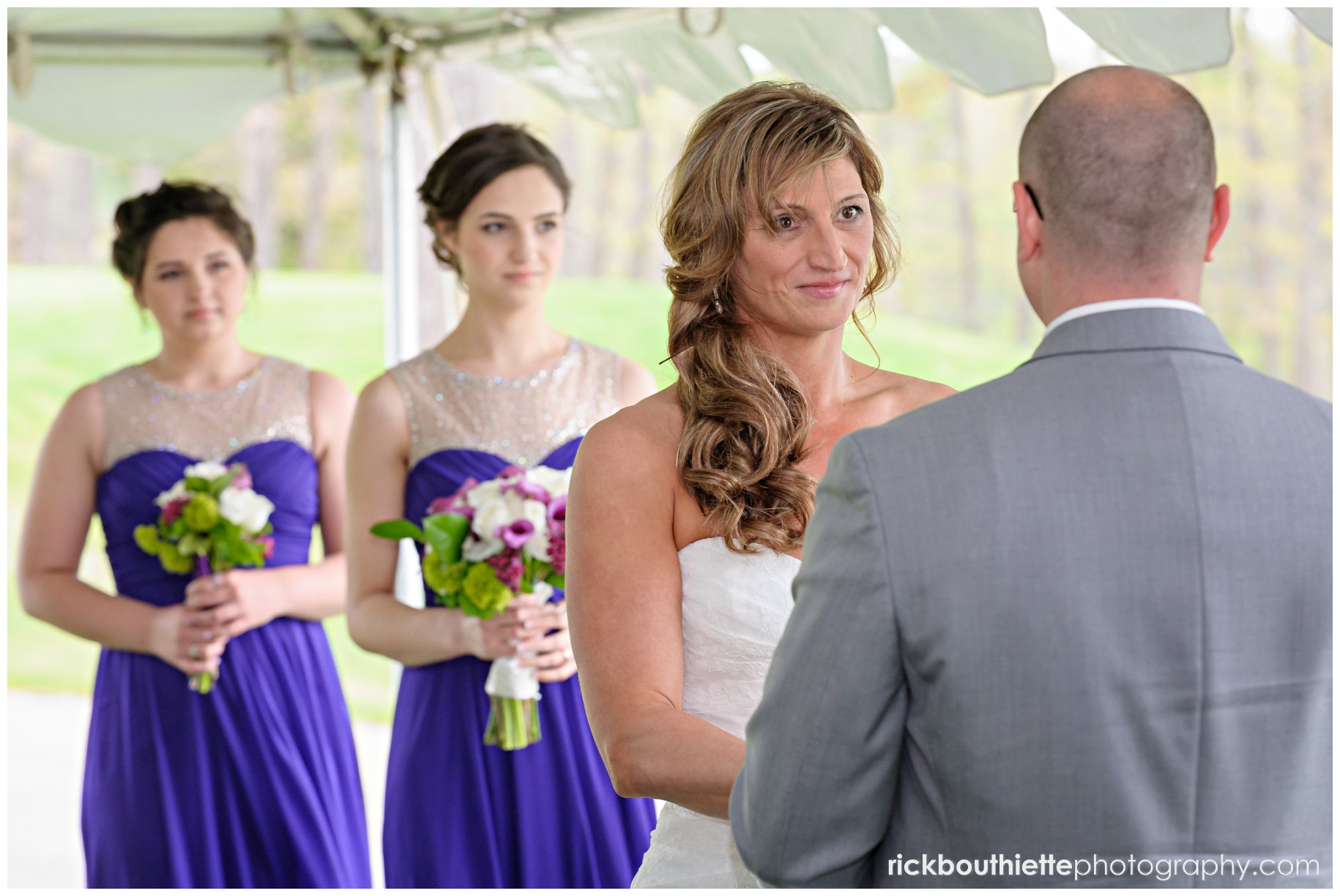 bride gazing at groom during wedding ceremony at The Oaks Grandview Ballroom wedding