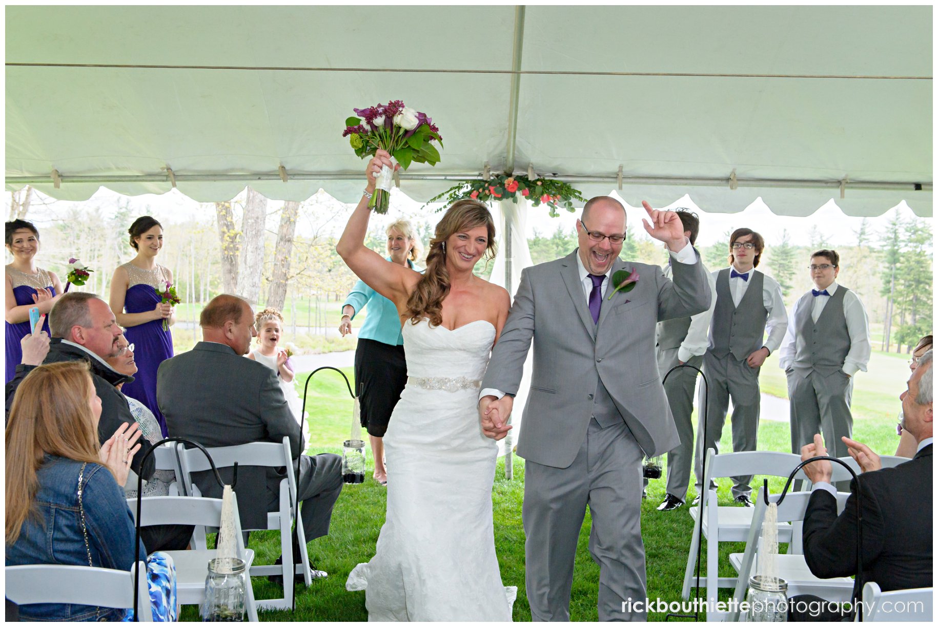 bride and groom celebrate as the walk down the aisle after their wedding ceremony at the Oaks