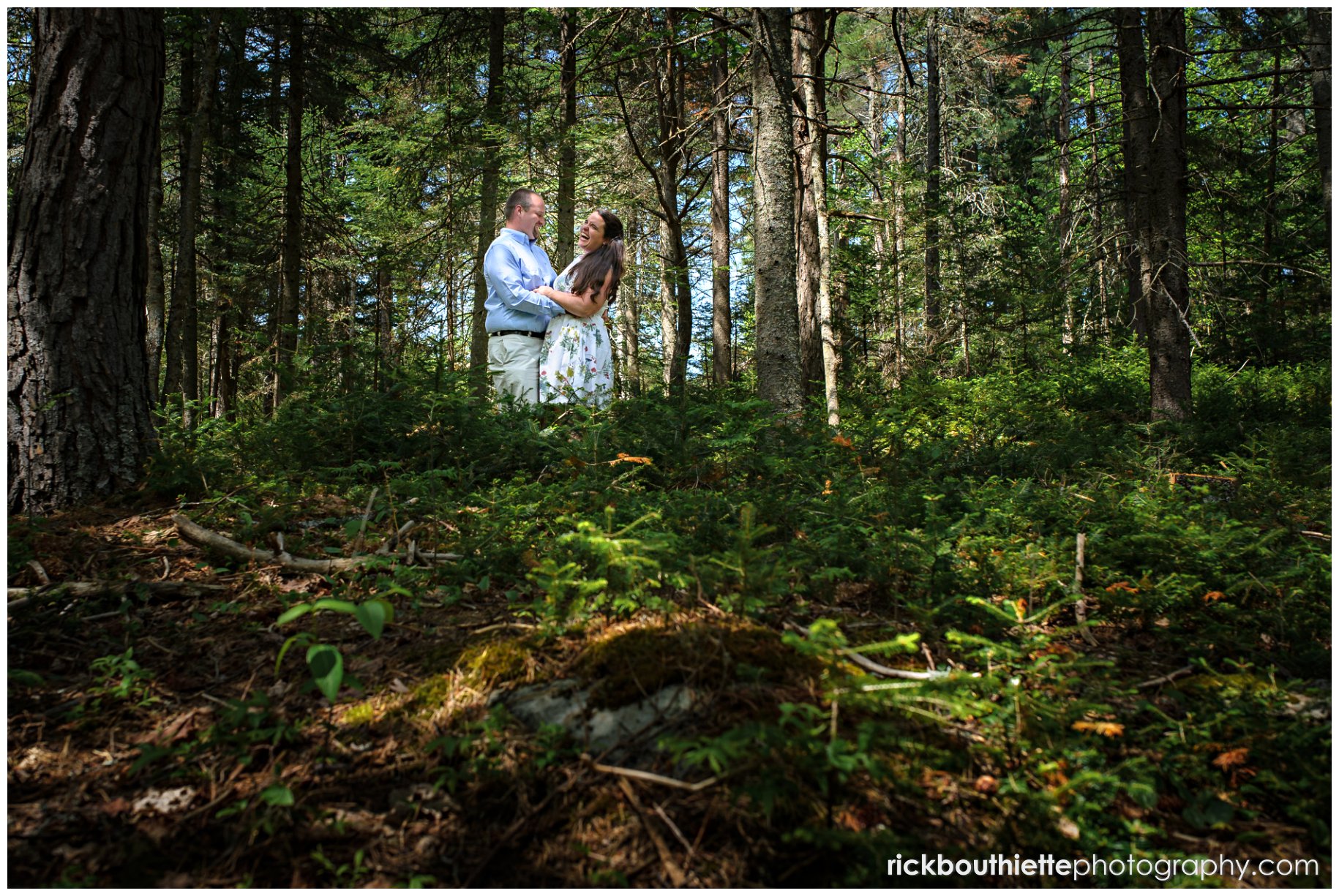 couple laughing in the woods at omni mount washington resort engagement session