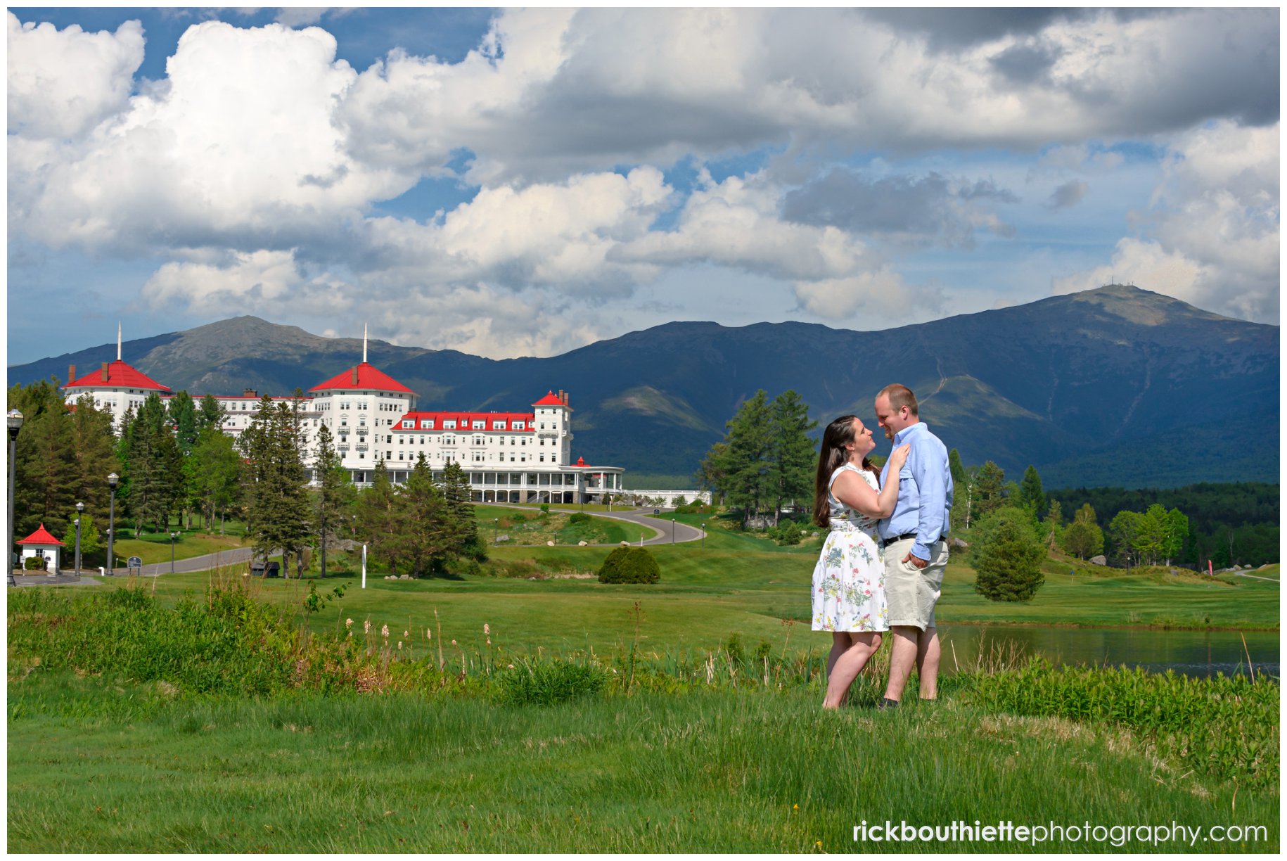 couple on the front lawn of the omni mount washington resort during engagement session