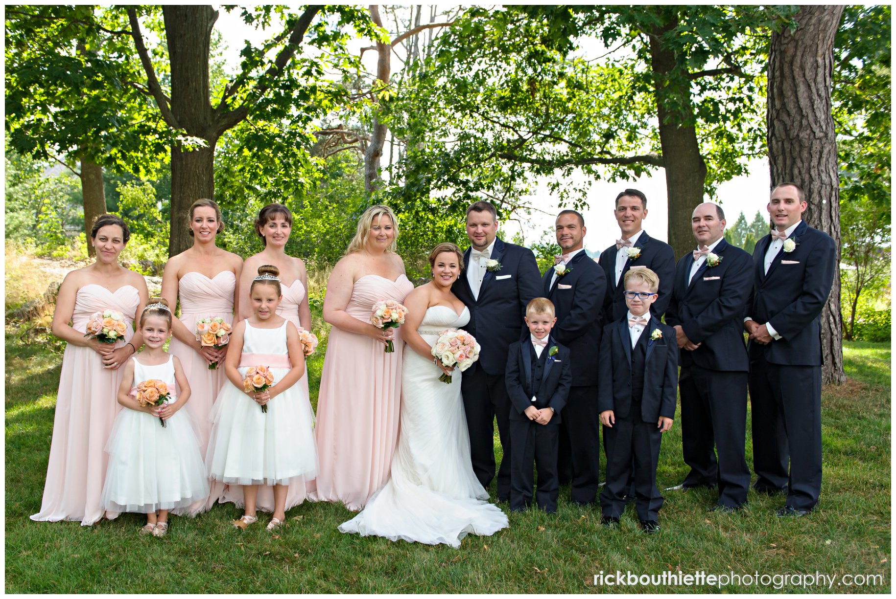 bride & groom in the garden with their wedding party at Wentworth By The Sea wedding