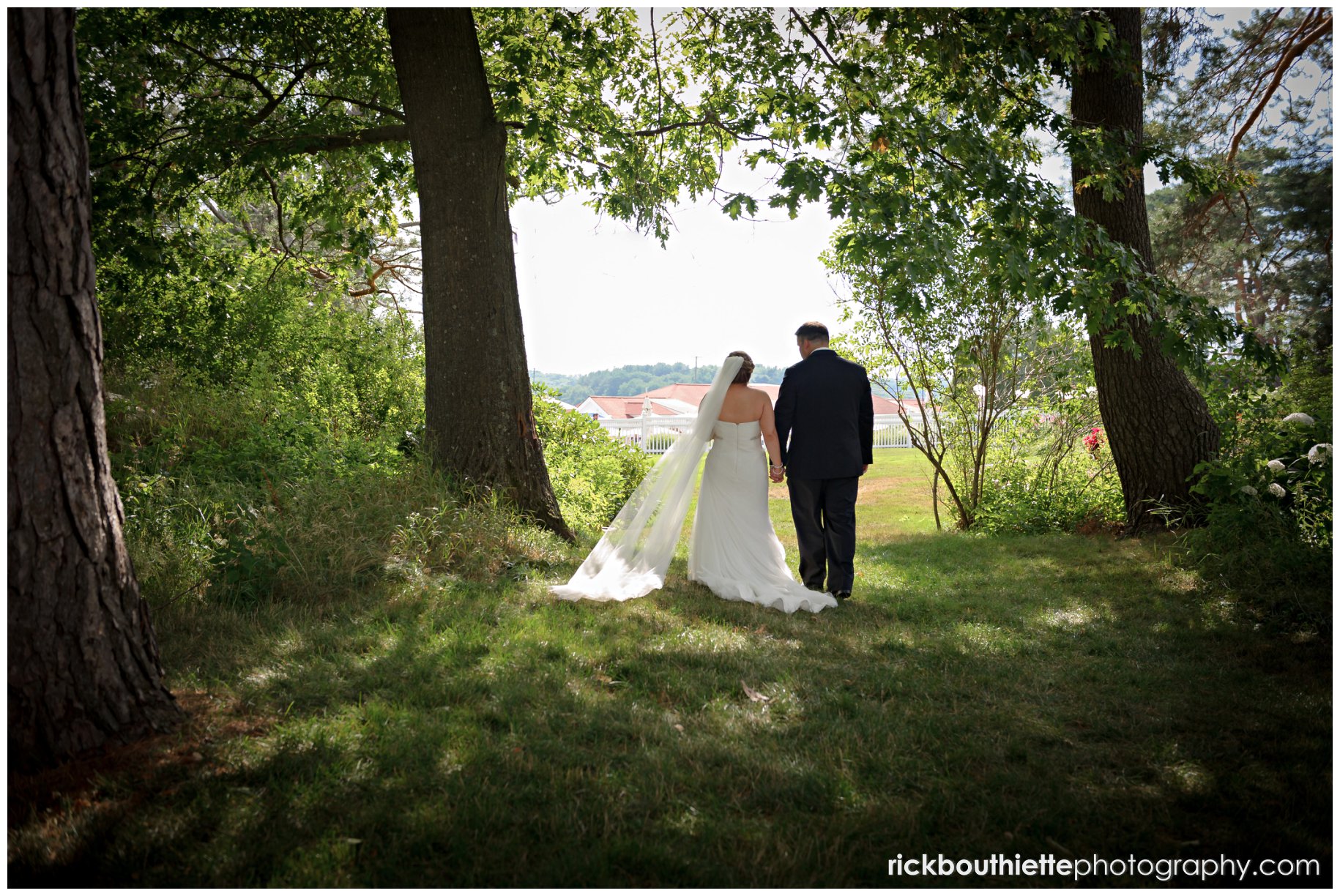 bride & groom walking in the garden at their Wentworth By The Sea wedding