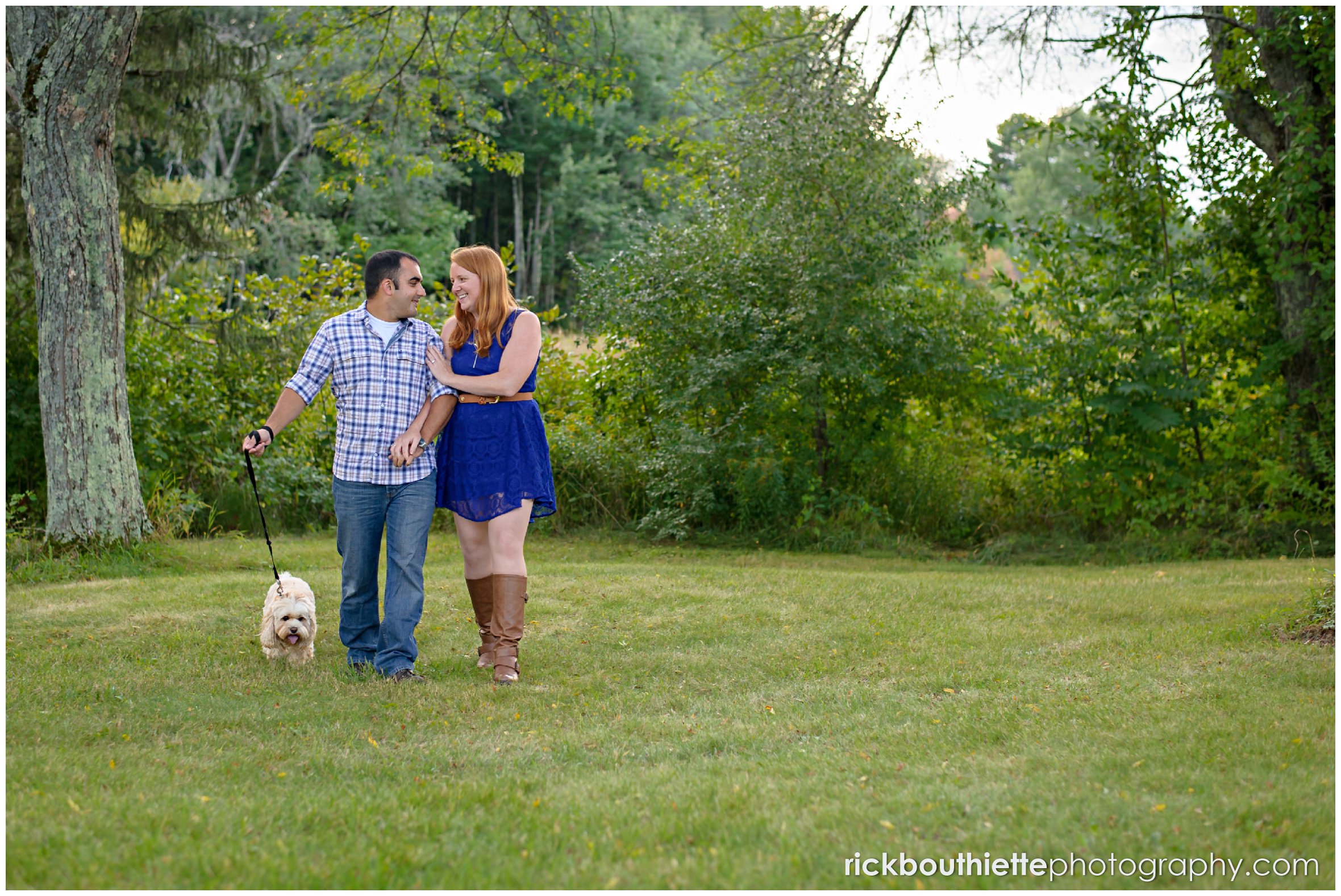 couple walking with their dog during NH engagement session