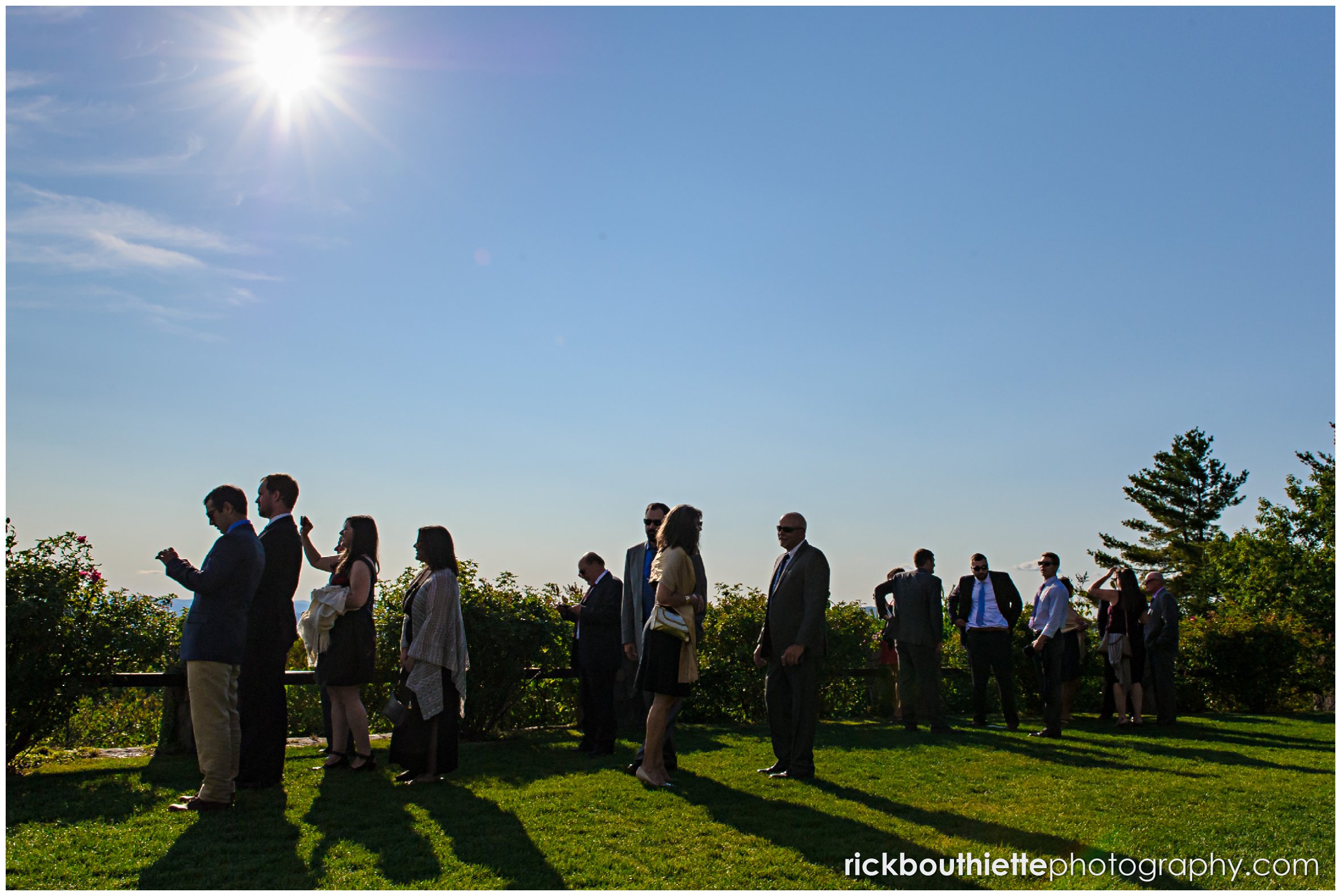 silhouette ofguests talking pictures of scenic vista at Castle In The Clouds wedding