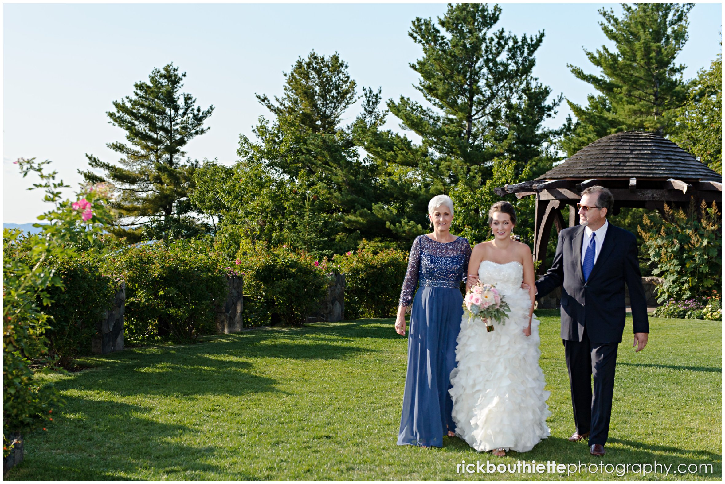 bride entering ceremony site with parents at Castle In The Clouds wedding