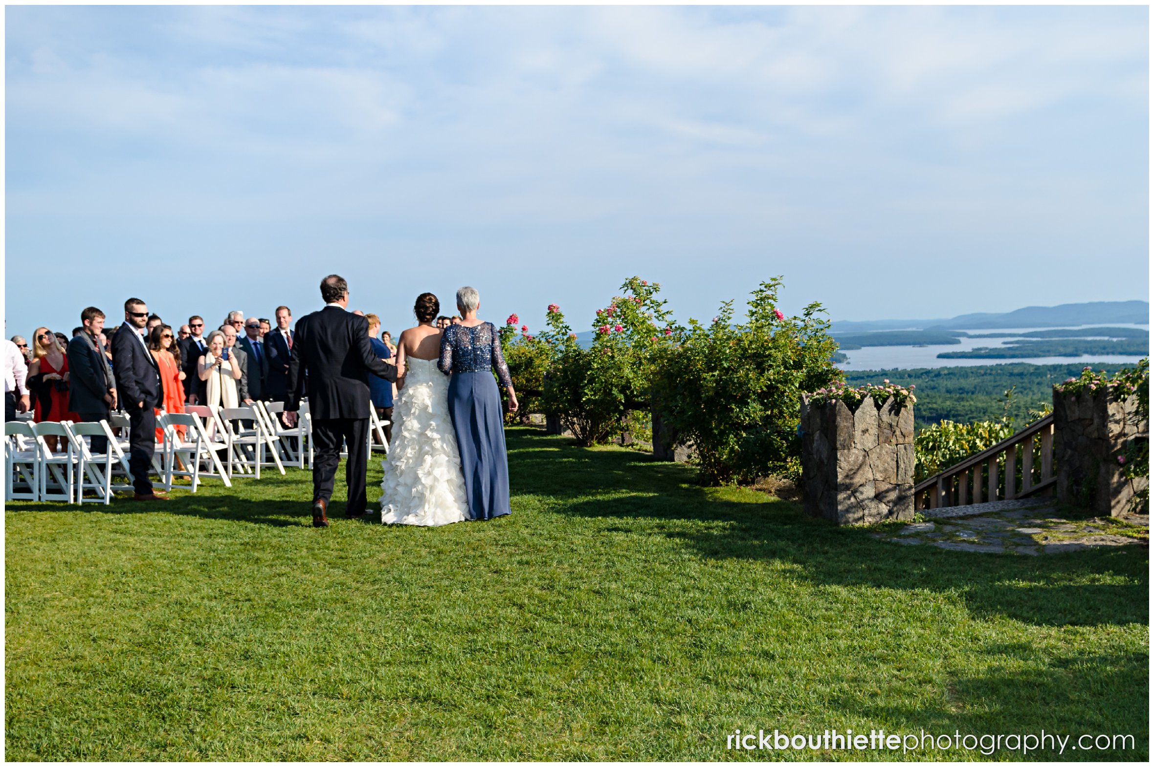 rear view bride walking down aisle with her parents at Castle In The Clouds wedding