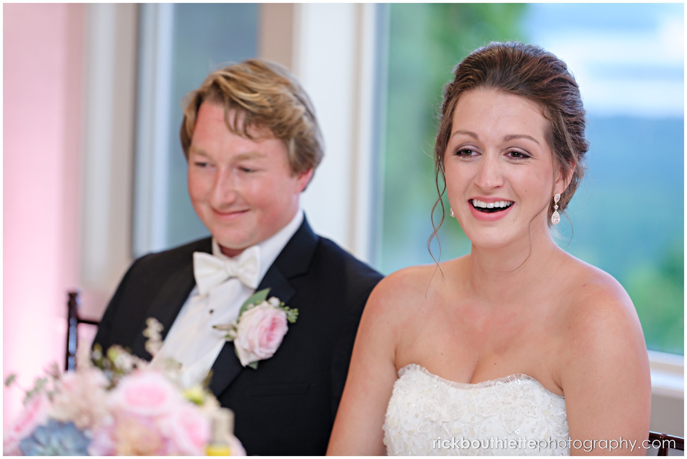bride and groom laughing during toast at Castle In The Clouds wedding