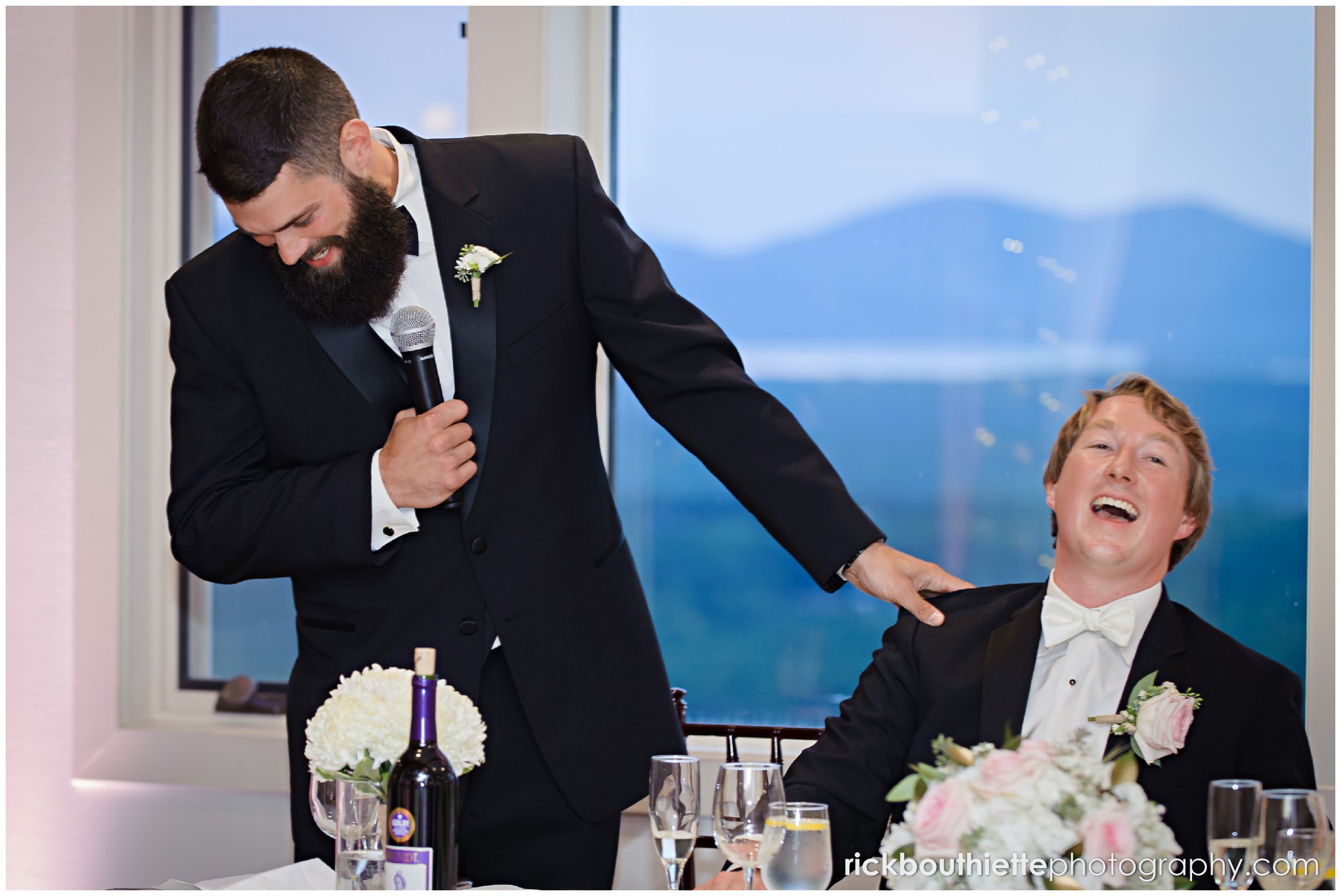 best man and groom laughing during toast at Castle In The Clouds wedding
