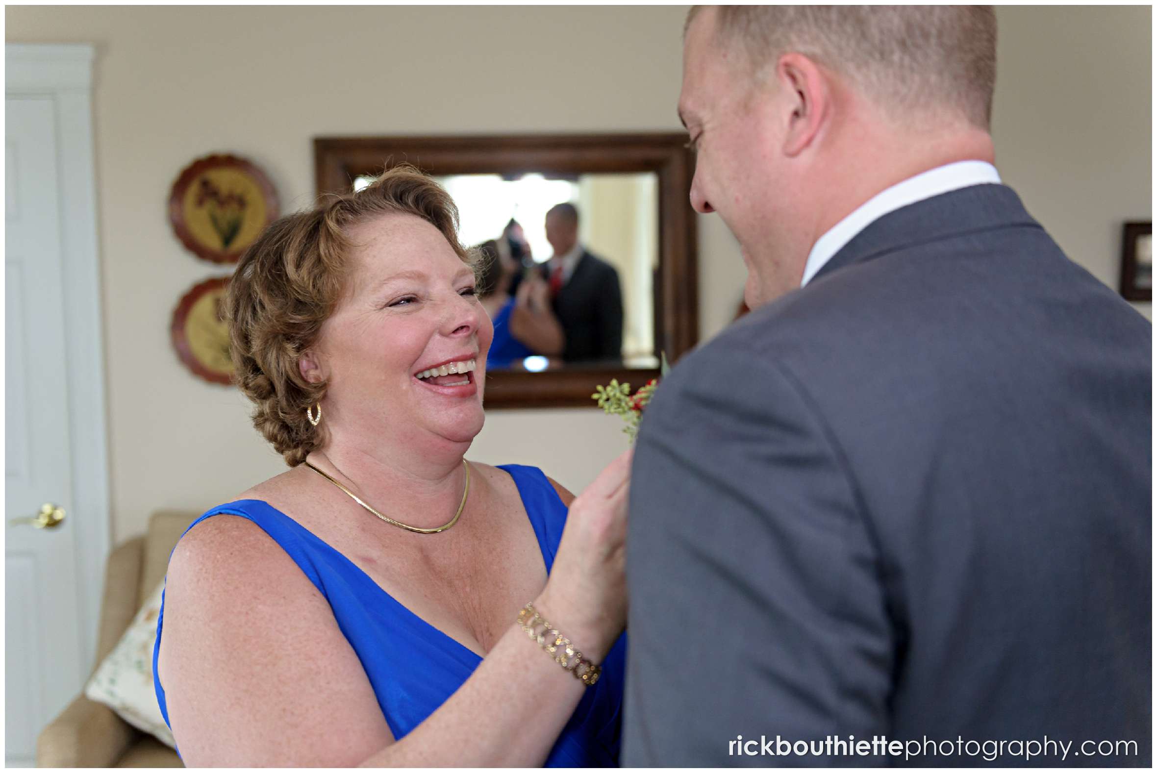 groom's mother helping him with final details at mountain view grand wedding