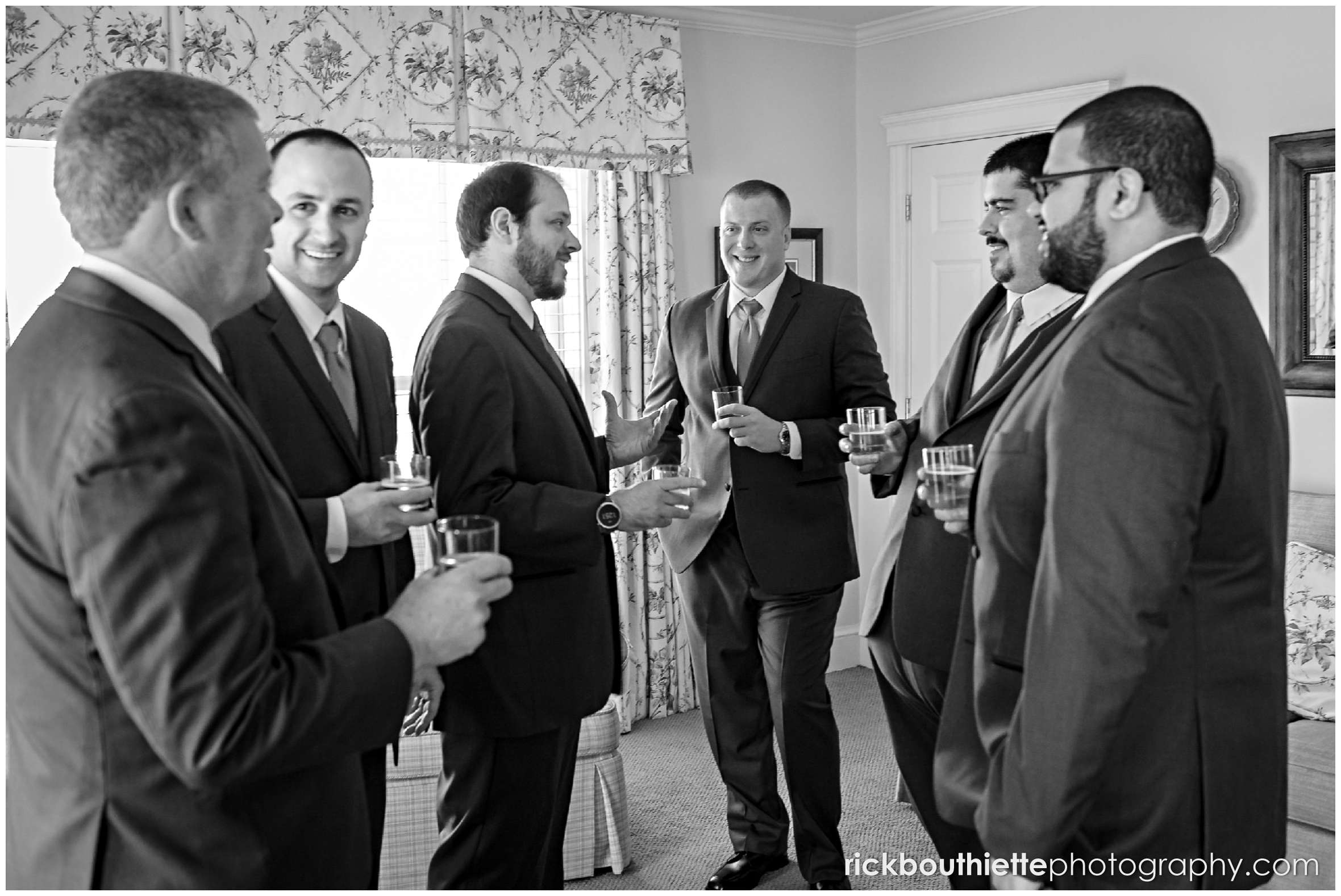 the groom and his groomsmen enjoy a shot before his wedding ceremony at the mountain view grand resort
