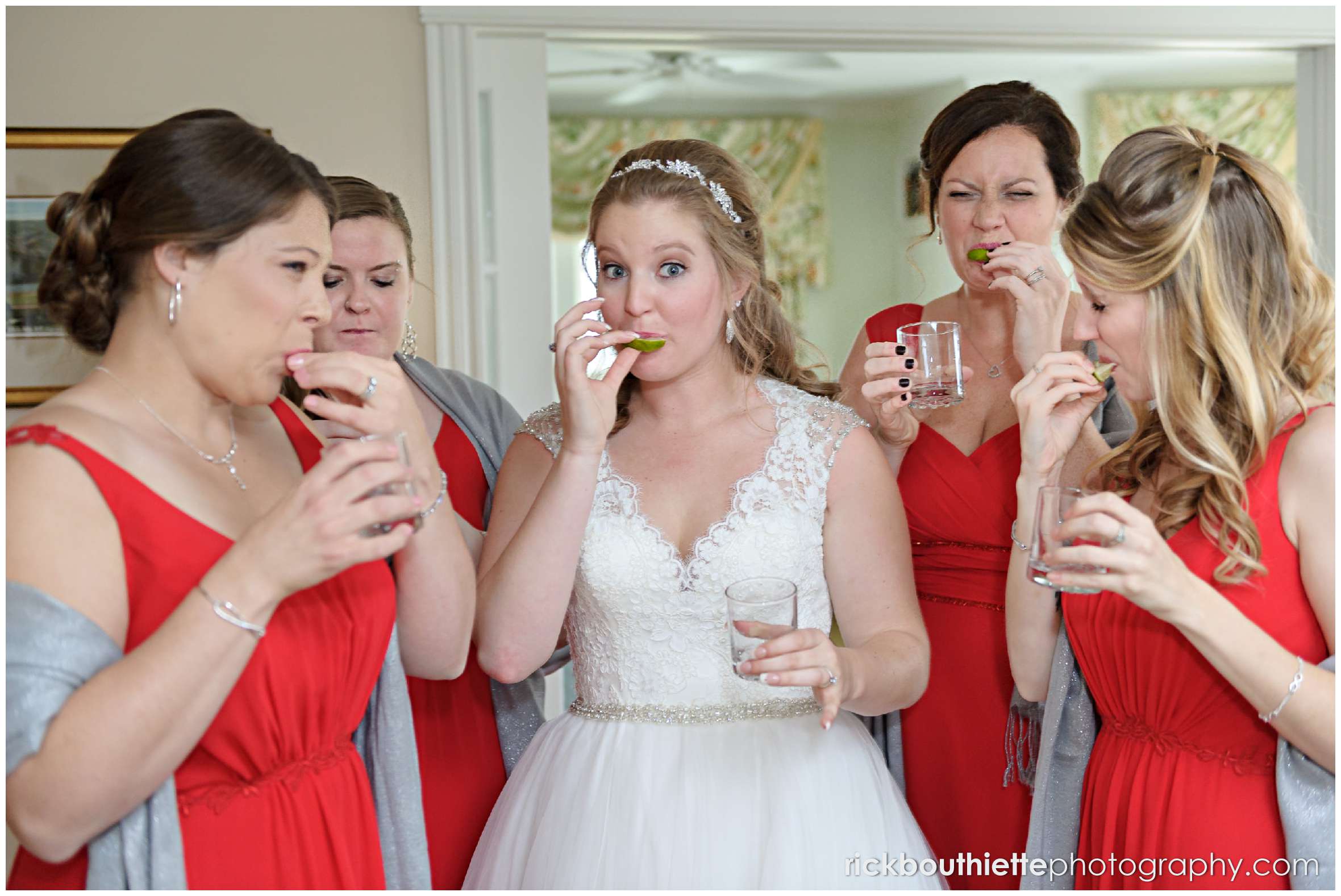 the bride and her bridesmaids enjoy a shot of tequila before her wedding ceremony at the mountain view grand resort