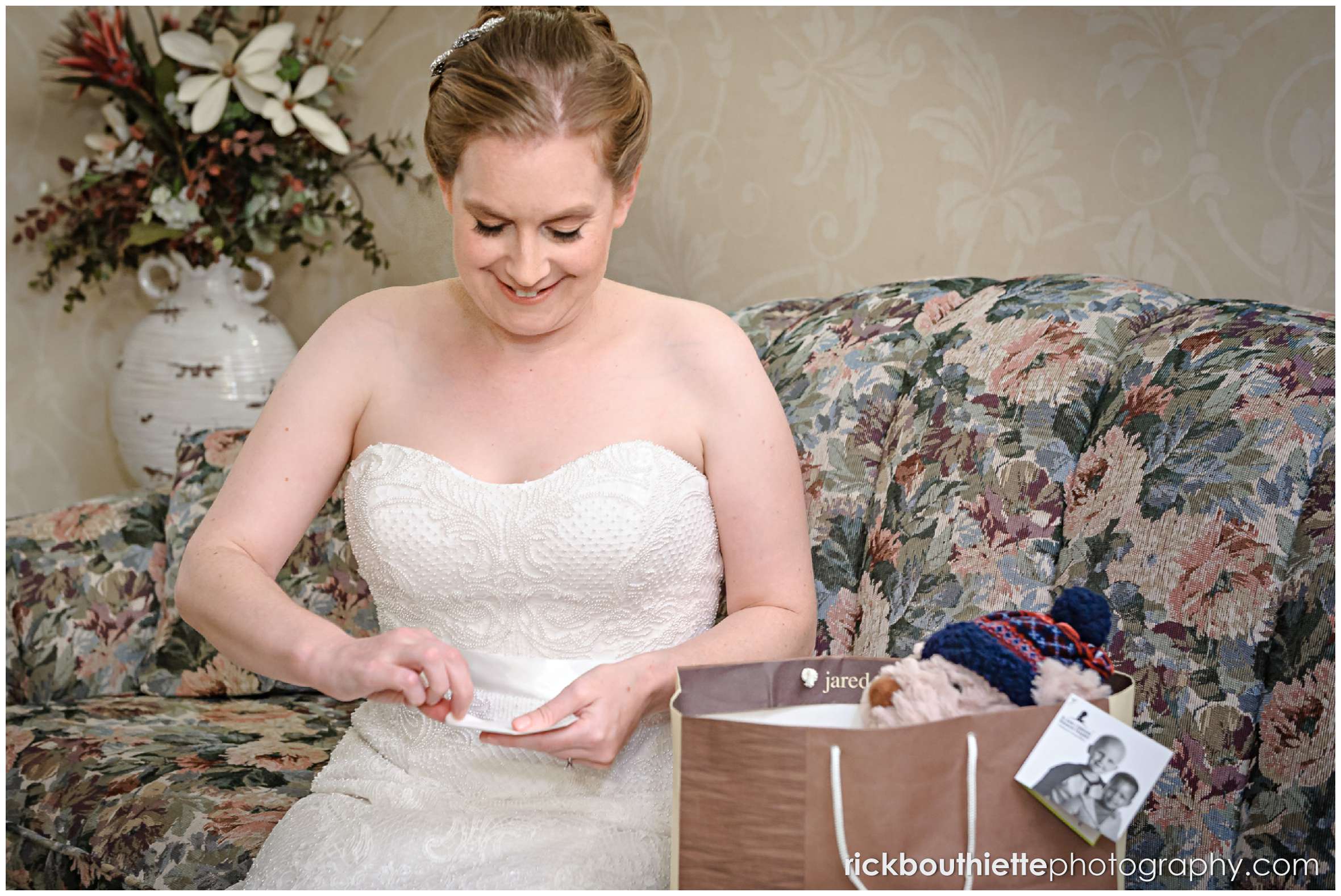 bride opening a card and gift from her husband to be before her seacoast wedding