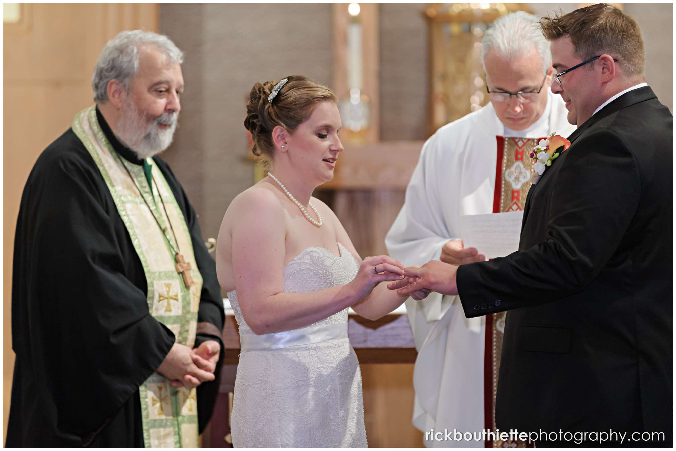 bride putting ring on groms finger at New Hampshire seacoast wedding ceremony