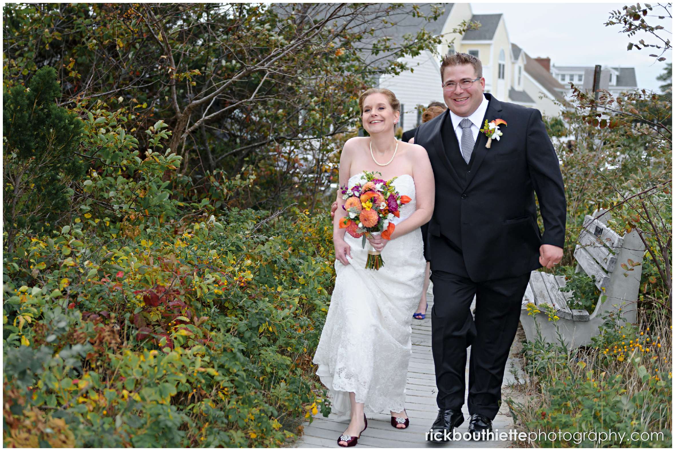 bride and groom on boardwalk at Seabrook beach wedding