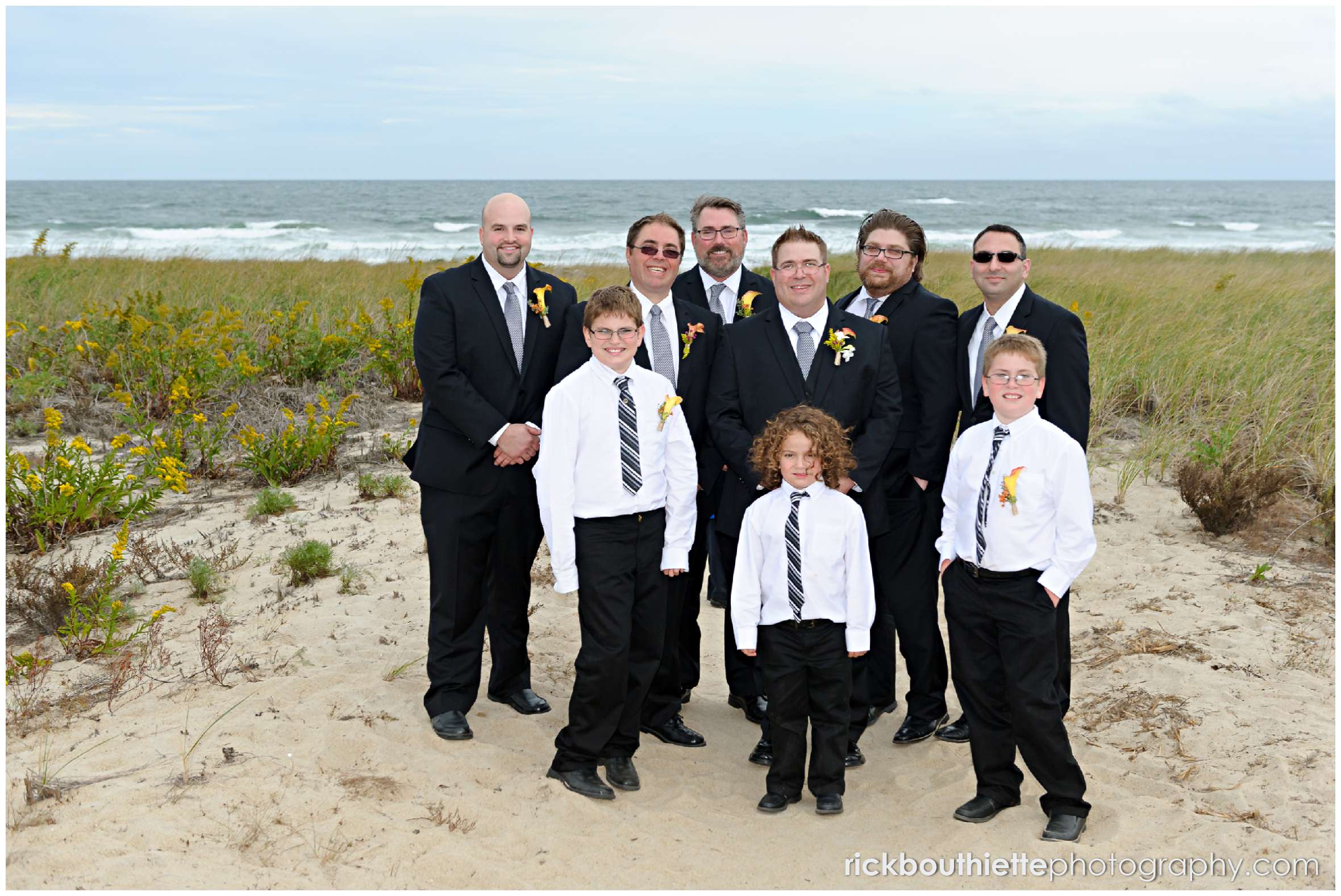 groom and groomsmen on beach after Seabrook NH seacoast wedding