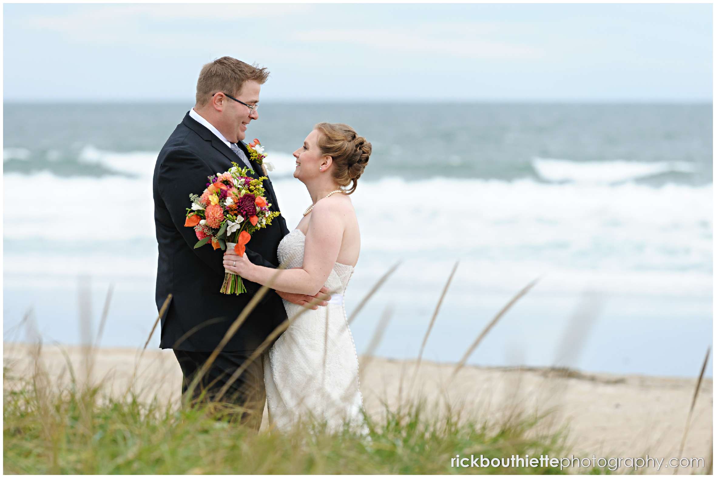 bride and groom spend time on Seabrook beach after their seacoast wedding ceremony