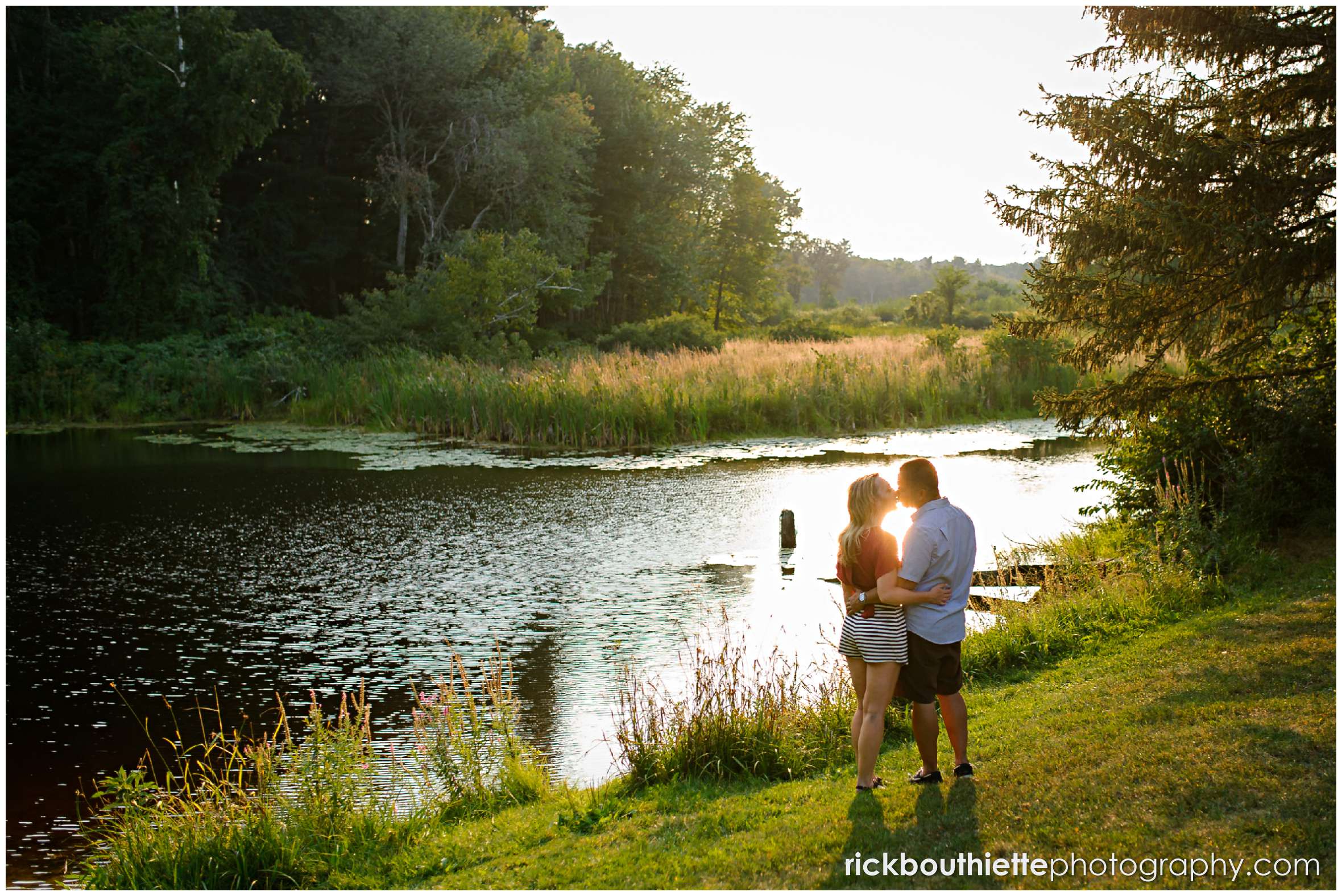 silhouette of couple by the pond at apple orchard engagement session