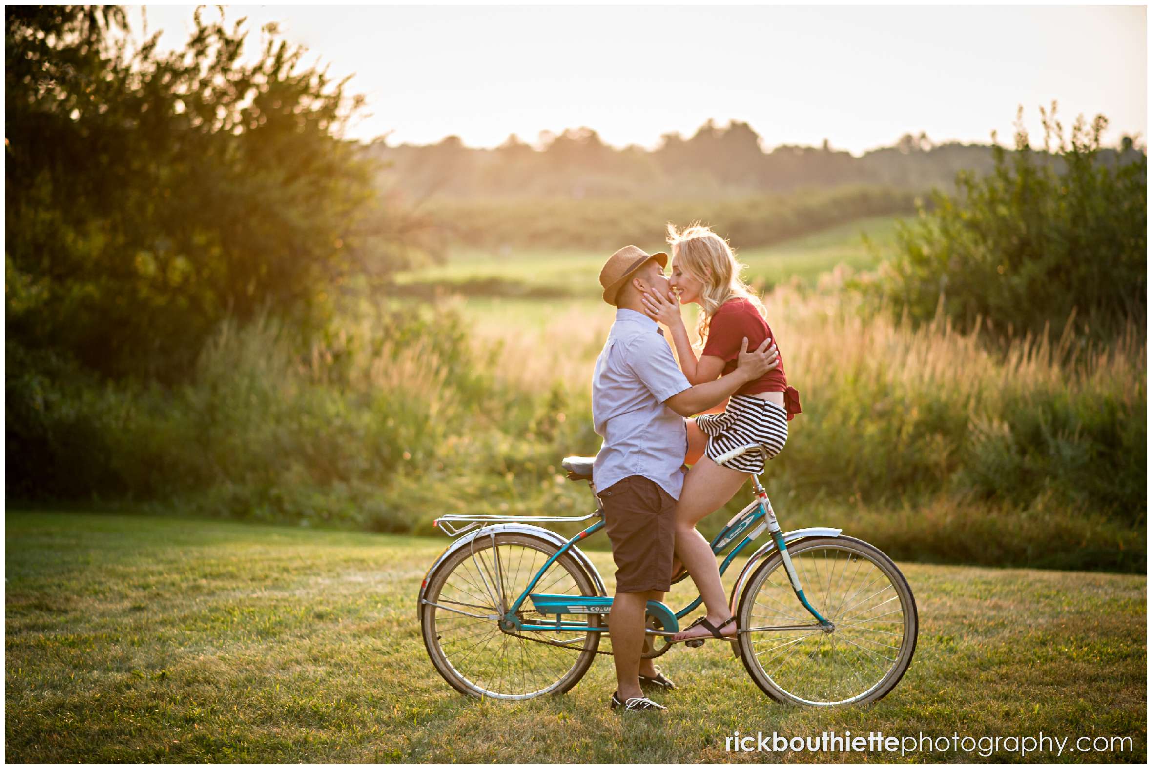 couple on vintage bicycle as the sun sets at their New Hampshire apple orchard engagement session