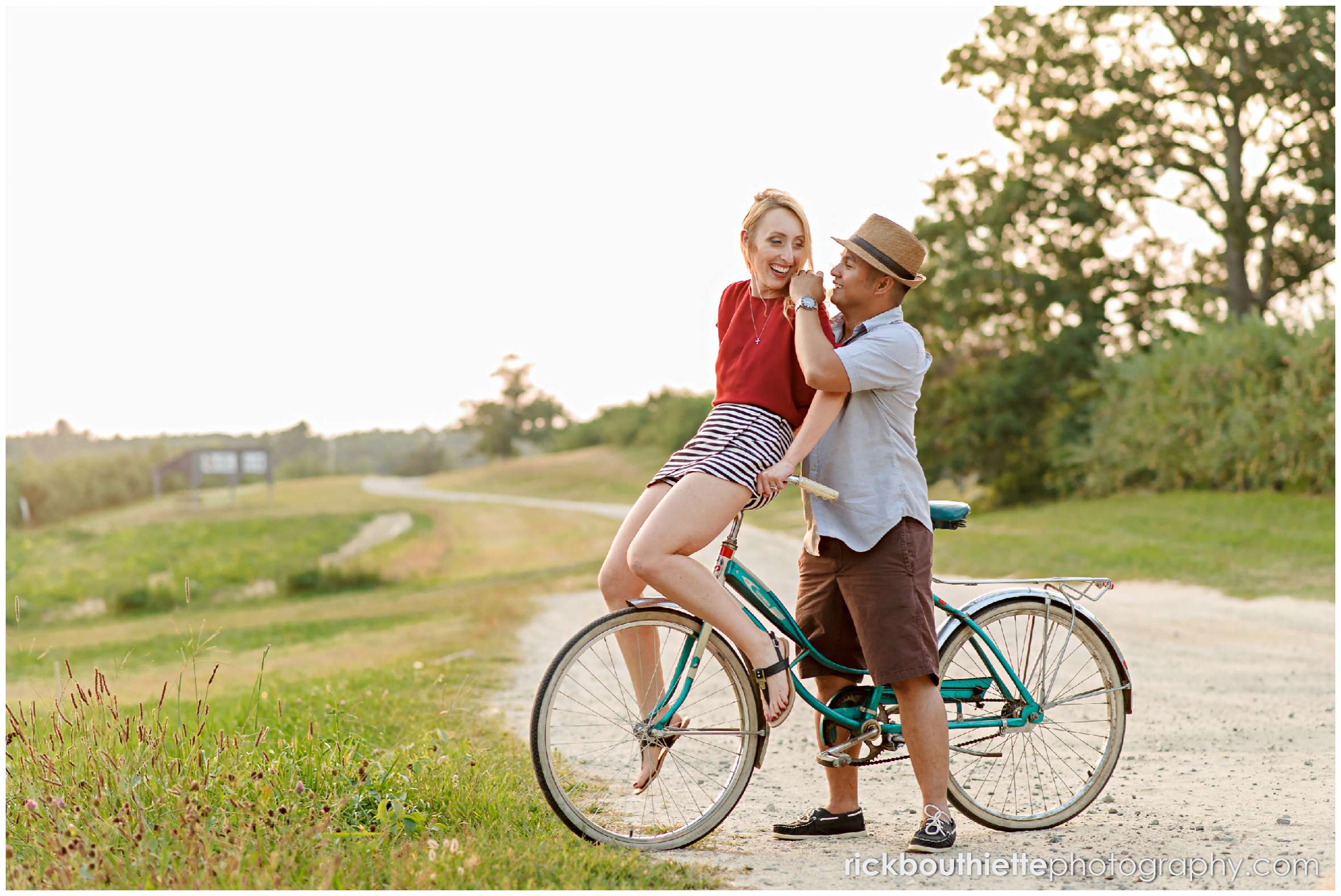 couple with vintage bicycle on dirt road at apple orchard engagement session