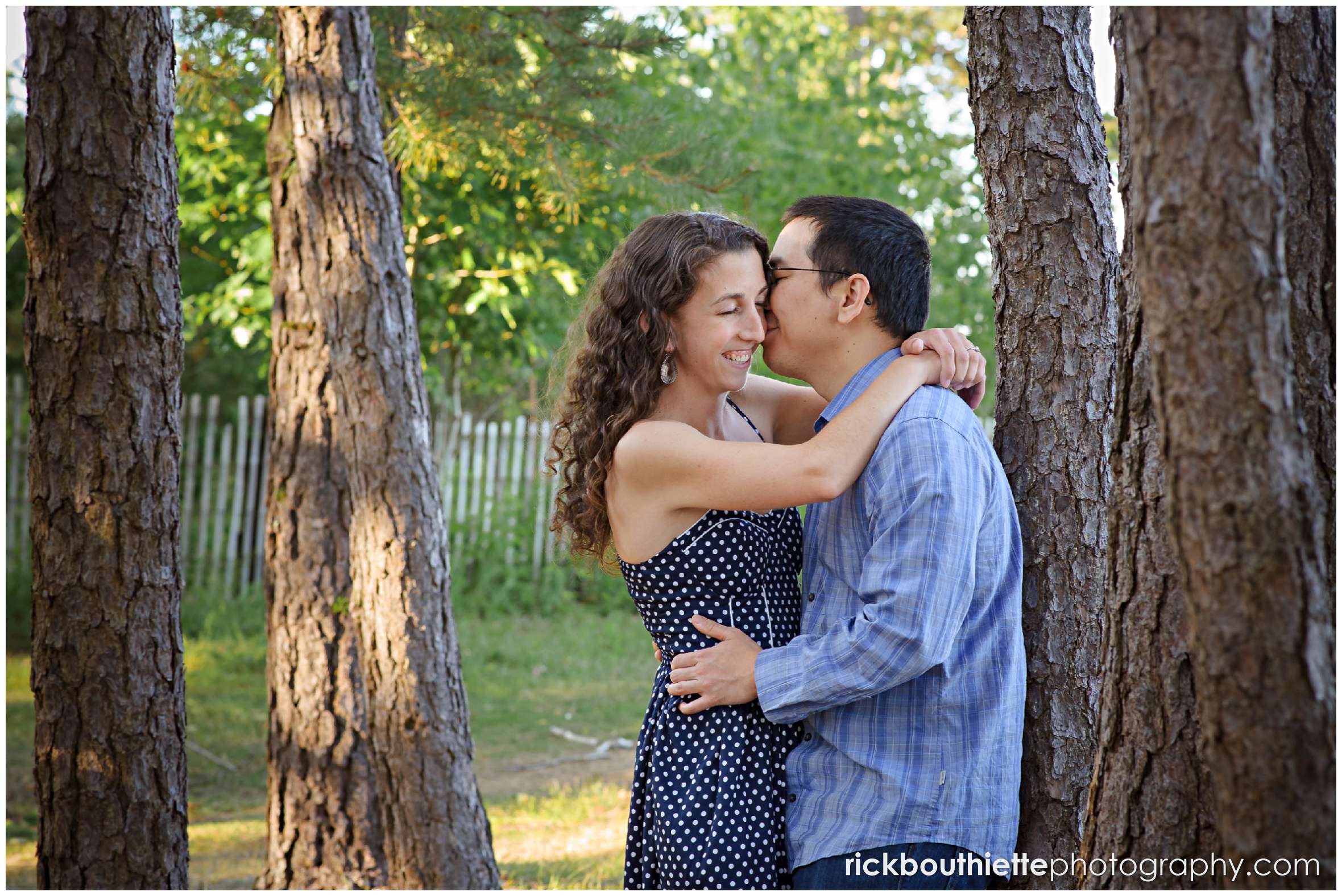 couple among the trees at their Great Island Common engagement session