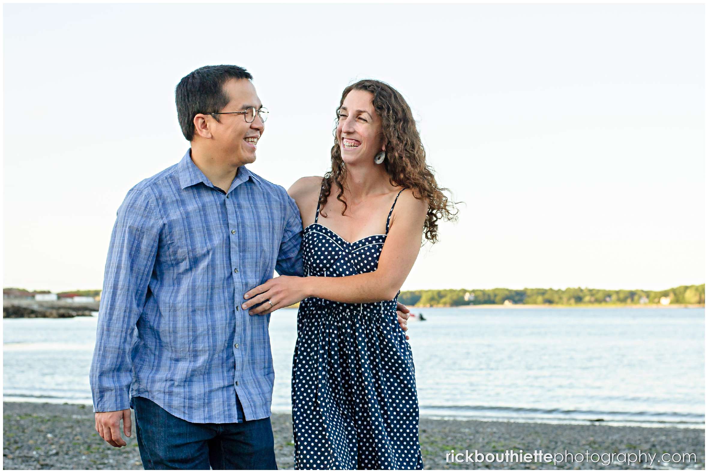 couple walking on the beach at their Great Island Common engagement session