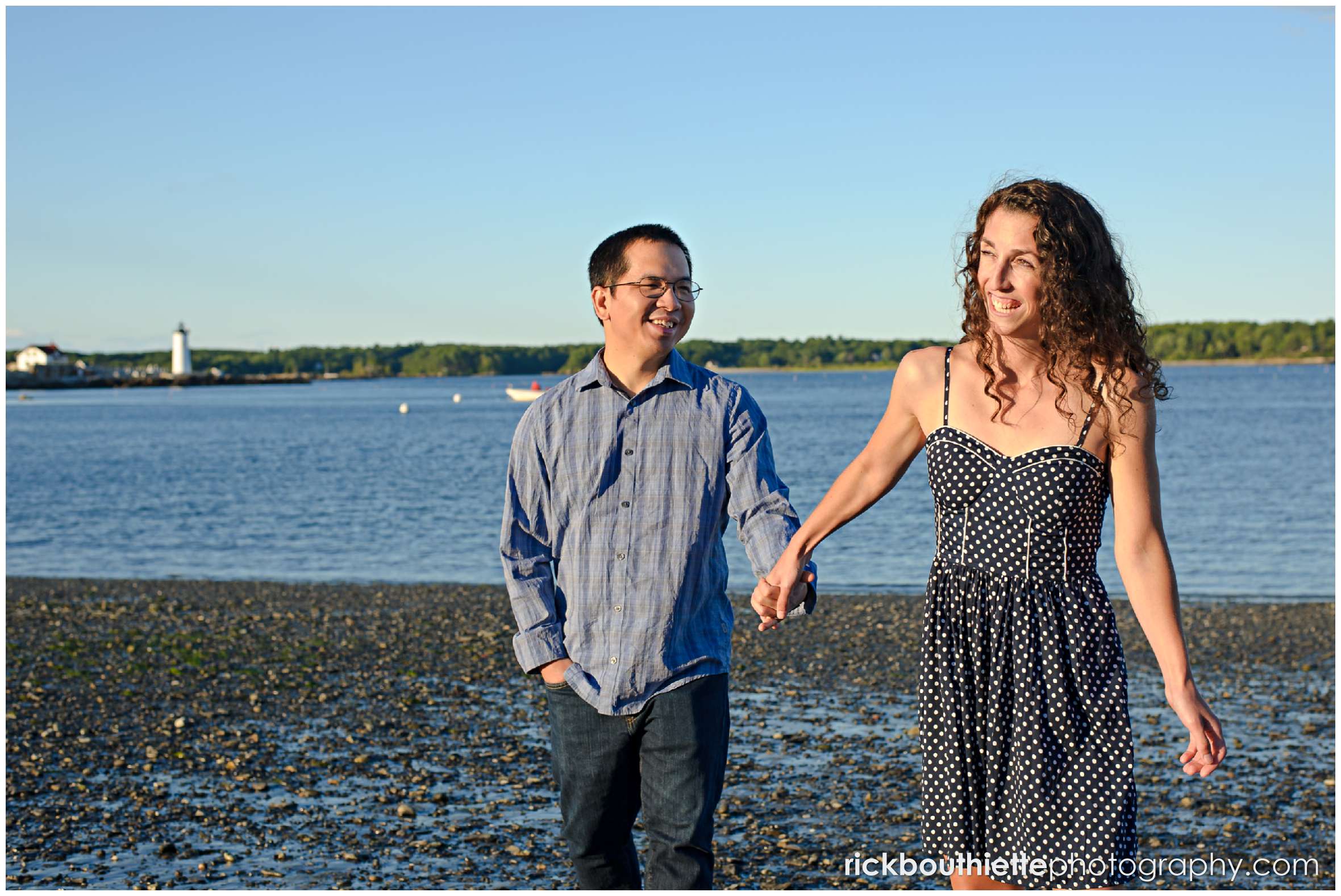 couple walking on the beach at their Great Island Common engagement session