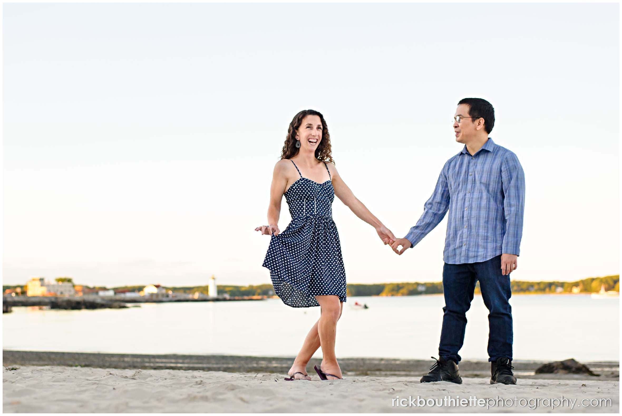 couple on the beach having fun at their Great Island Common engagement session