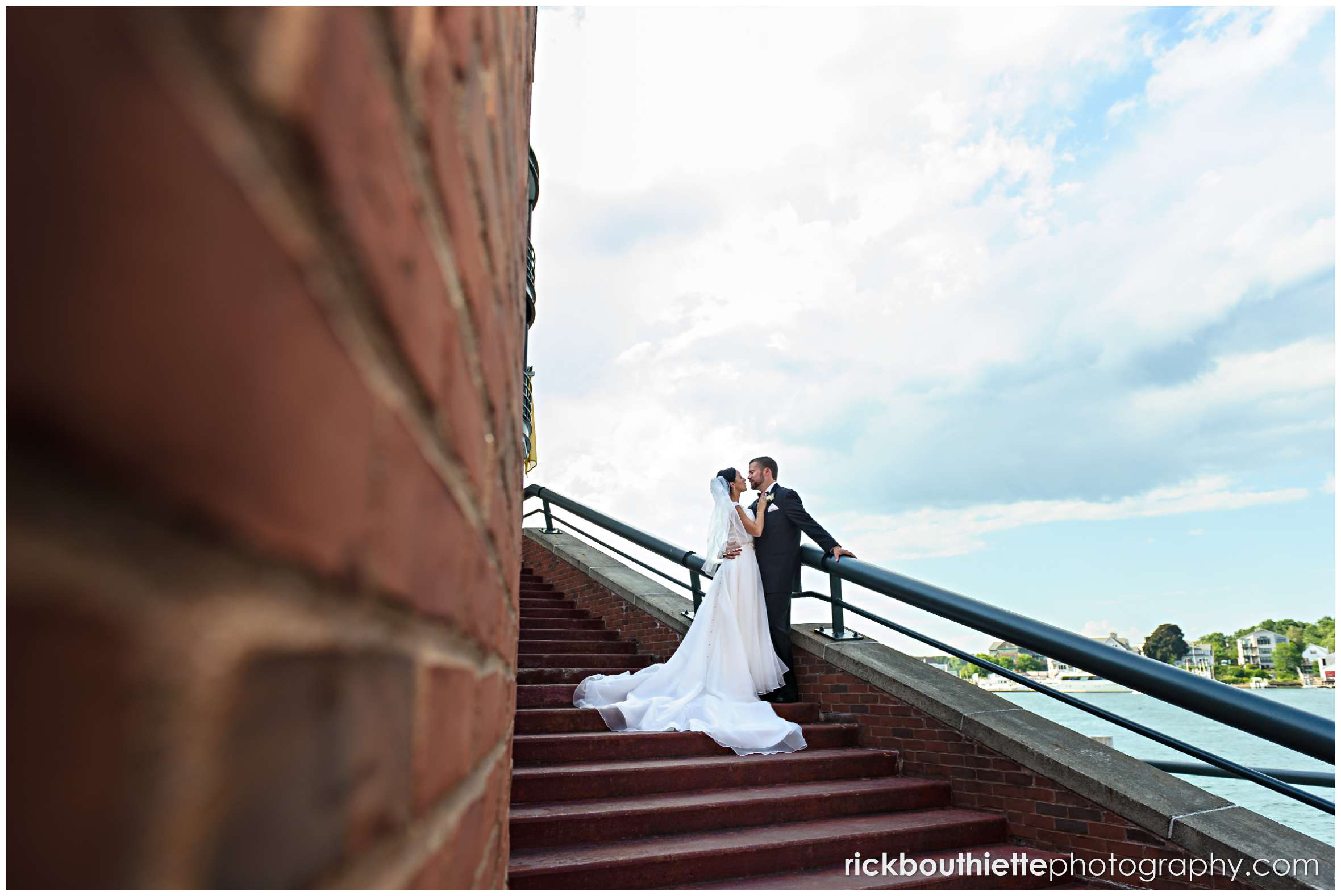 bride and groom on stairs in Portsmouth New Hampshire seacoast