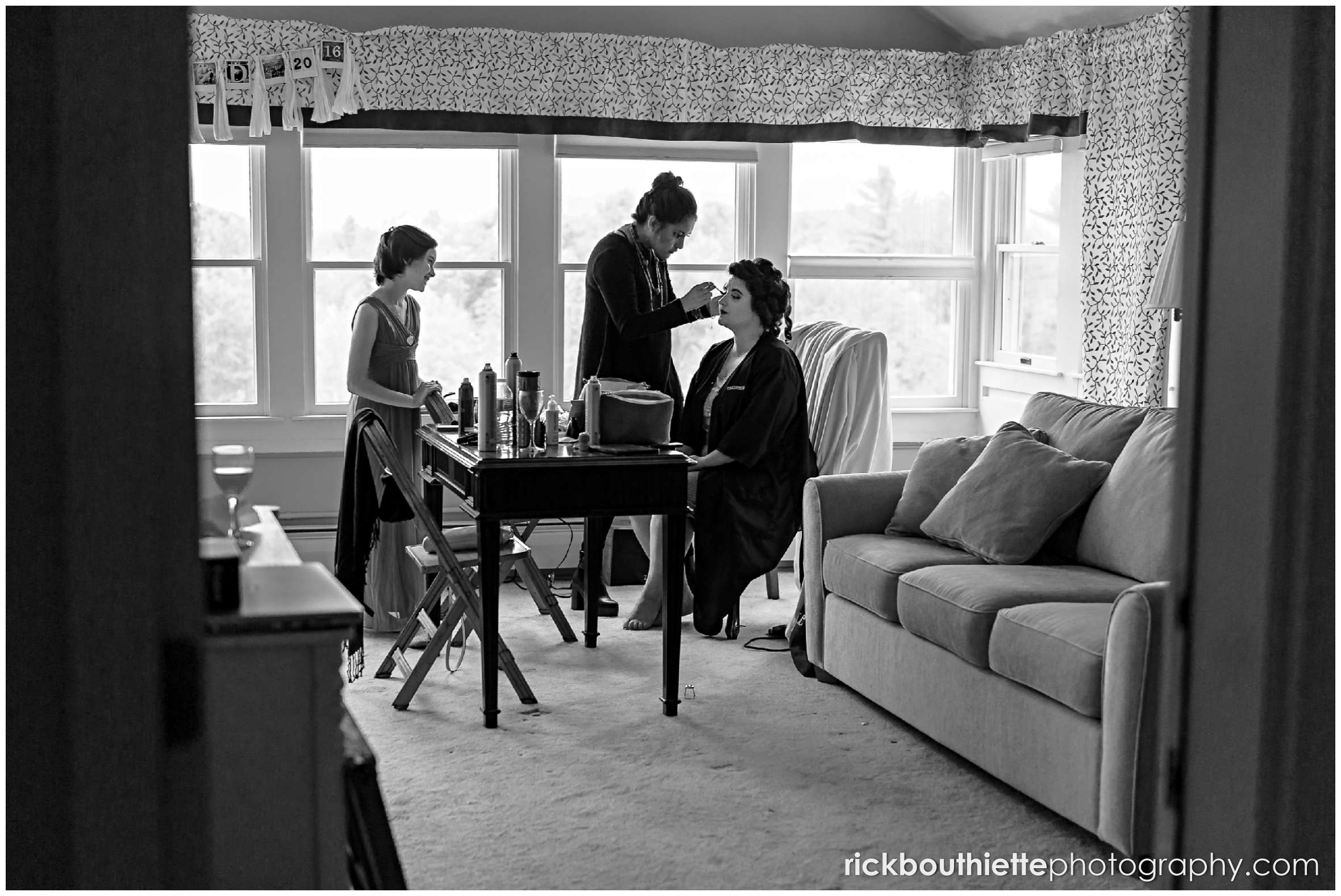 peeking in on bride and bridesmaids getting ready for Snowvillage Inn wedding