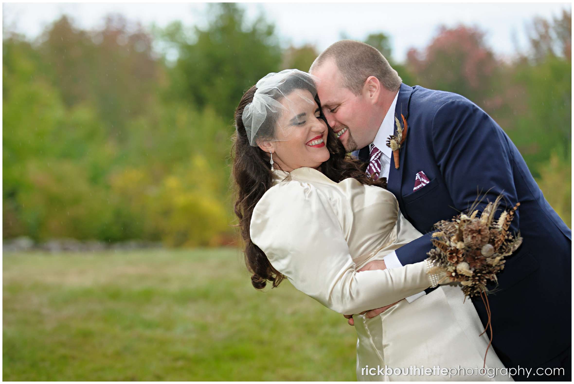 bride and groom laughing as they embrace at Snowvillage Inn fall wedding