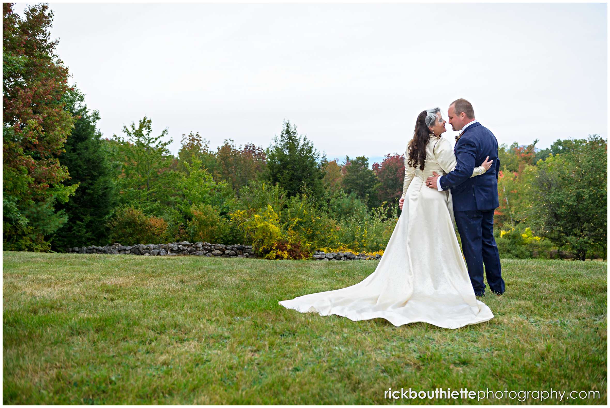 bride and groom enjoying the fall foliage after their wedding ceremony