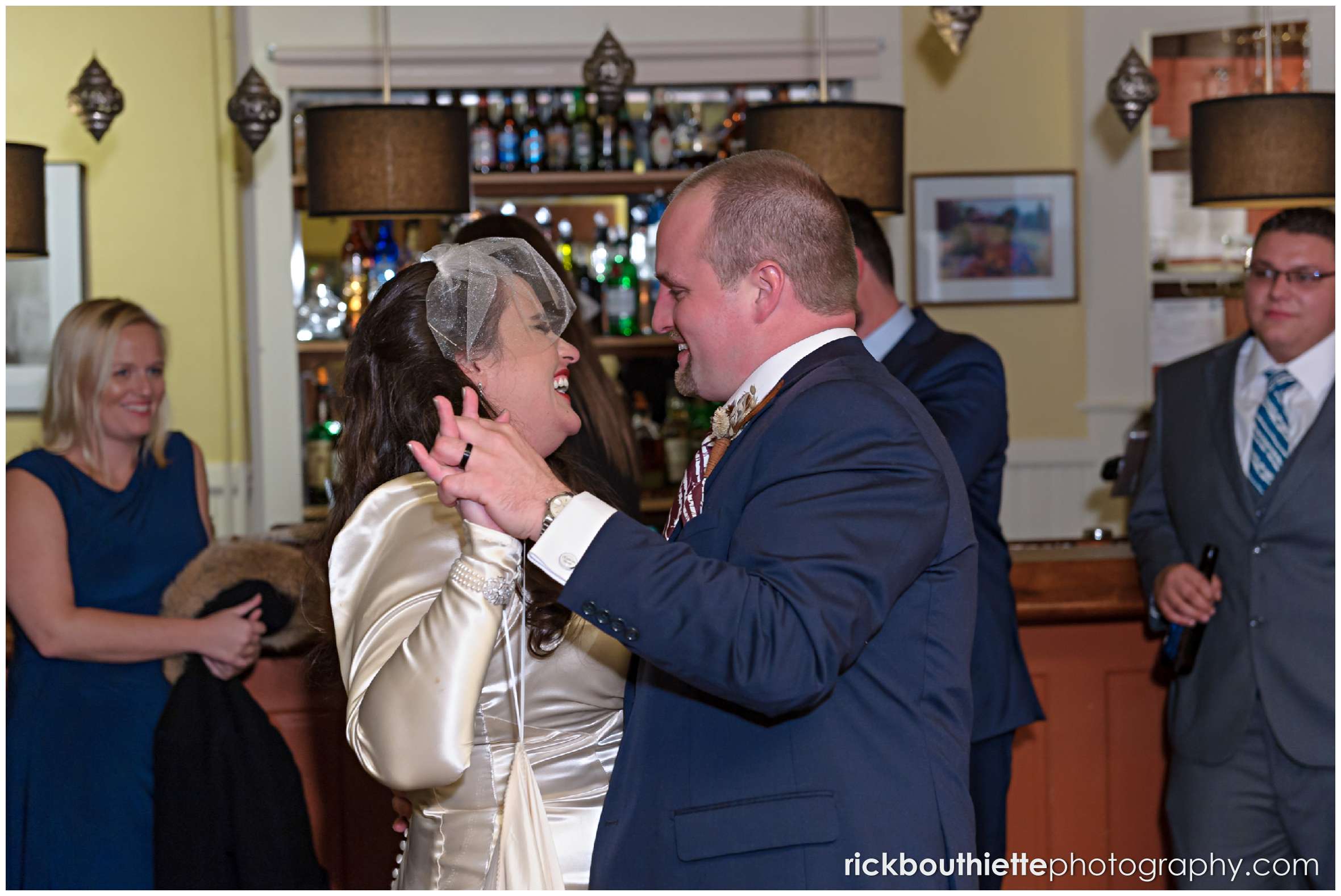 bride and groom have their first dance in the bar at their Snowvillage Inn wedding