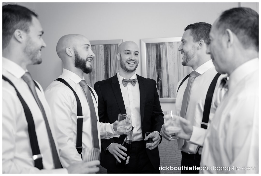 groom and his groomsmen celebrate before leaving for wedding at Candia Woods Evergreen Pavilion
