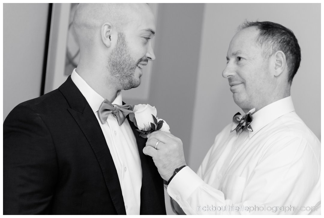 groom's father pins the boutinniere on his son prior to Candia Woods wedding
