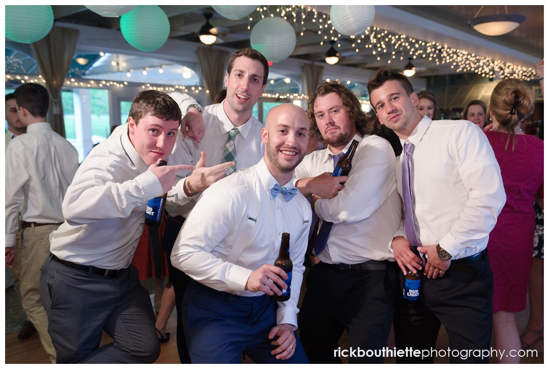 groom and friends pose for a picture on the dance floor at Candia Woods wedding