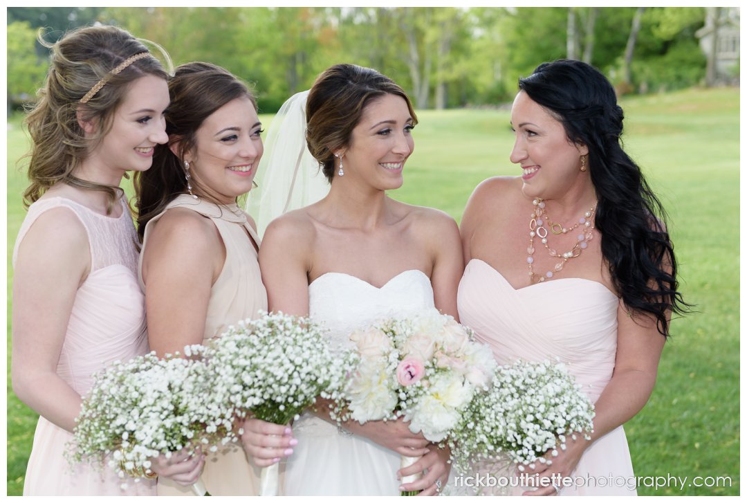bride and her bridesmaids pose for a picture at Candia Woods wedding