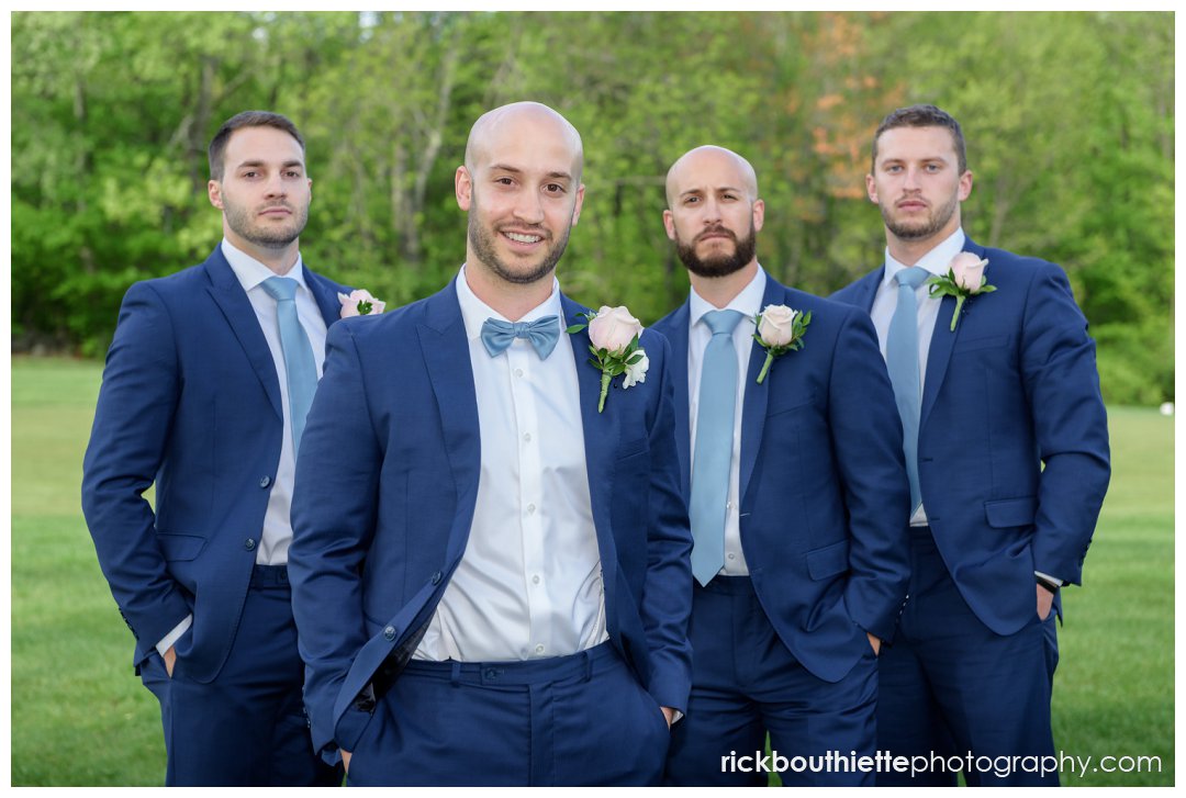 groom and his groomsmen looking good as they pose for a picture at Candia Woods wedding