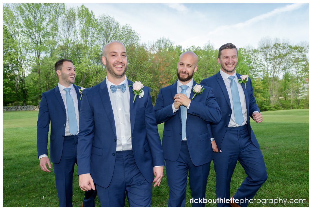 groom and groomsmen walking and laughing at Candia Woods wedding