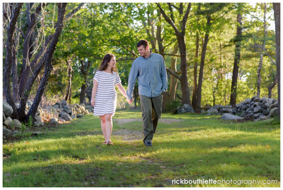 couple walking hand in hand at Ordiorne Point during their seacoast engagement session