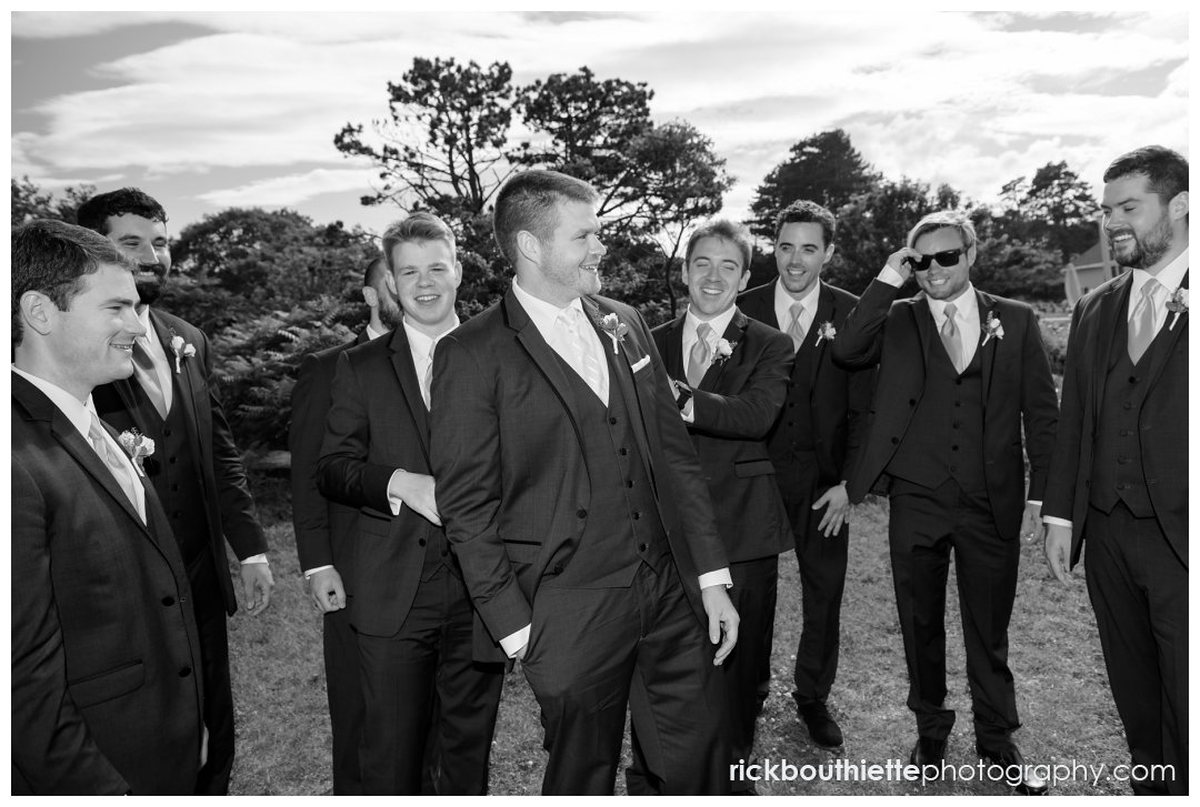 candid moment of groom and groomsmen at Seacoast Science Center wedding