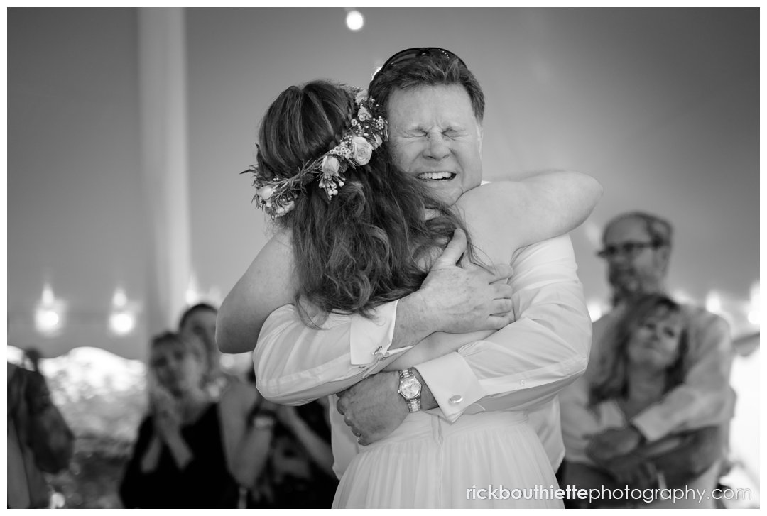 emotional father embraces bride at end of father daughter dance