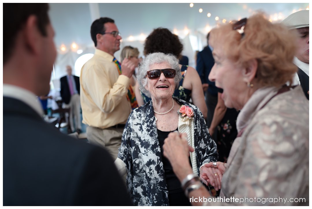 fun moment of grandmother of the bride dancing with sunglasses on at New Hampshire Seacoast Science Center wedding