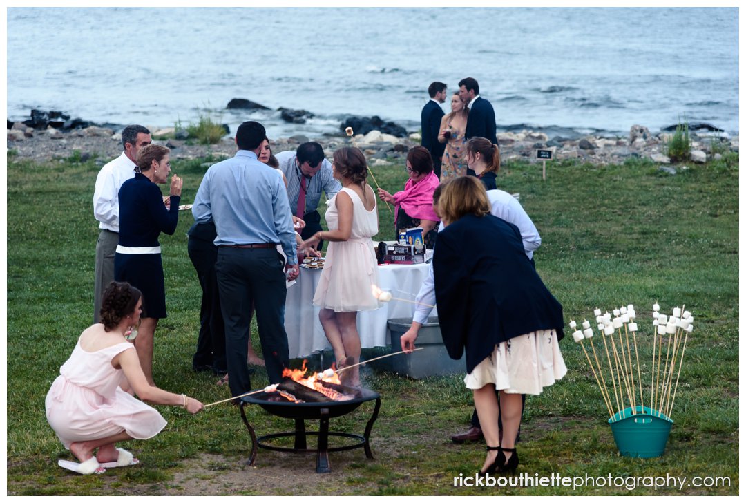 guests enjoying S'mores by the fire at New Hampshire Seacoast Science Center wedding reception