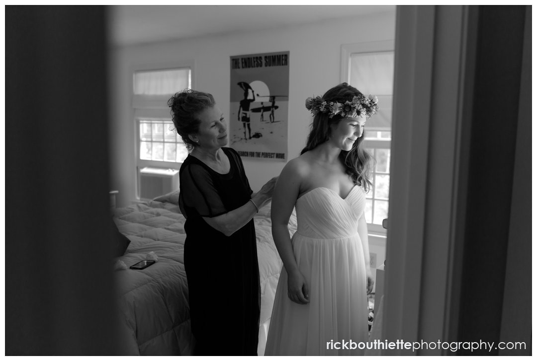 mother helping bride with finishing touches in preparation for her Rye, NH wedding