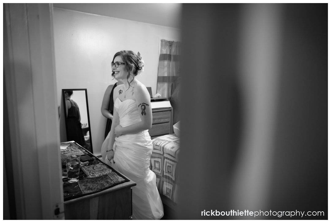 bride takes one last look in the mirror before leaving for her New Hampshire backyard summer wedding