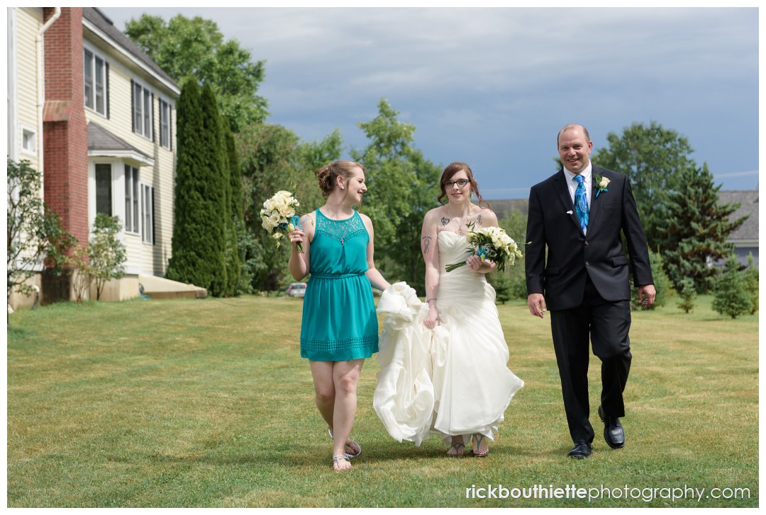 bride walking to ceremony at New Hampshire backyard summer wedding
