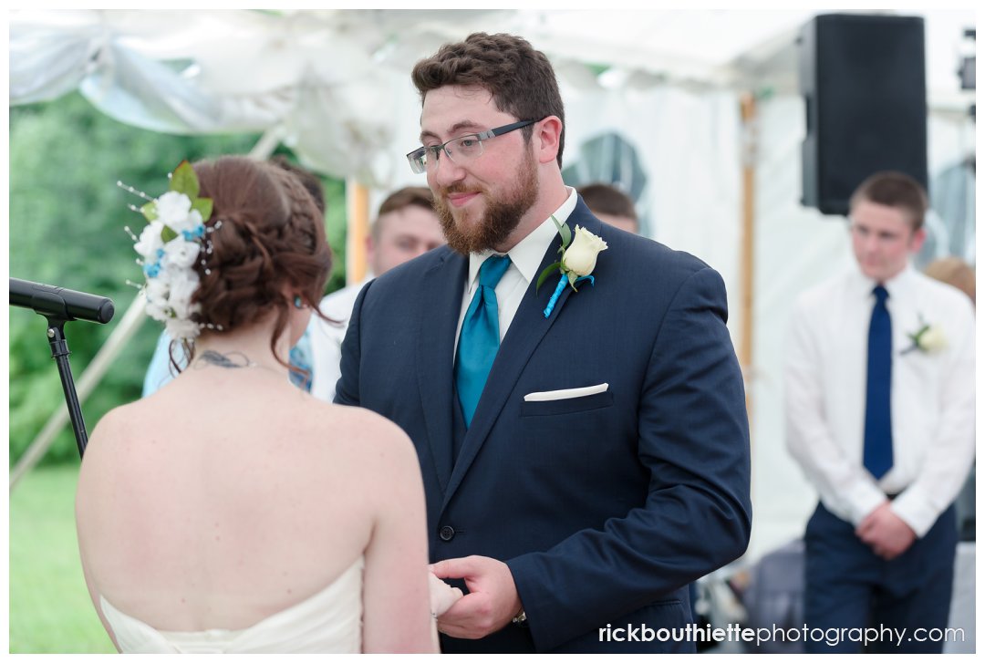bride and groom exchanging vows at New Hampshire backyard summer wedding
