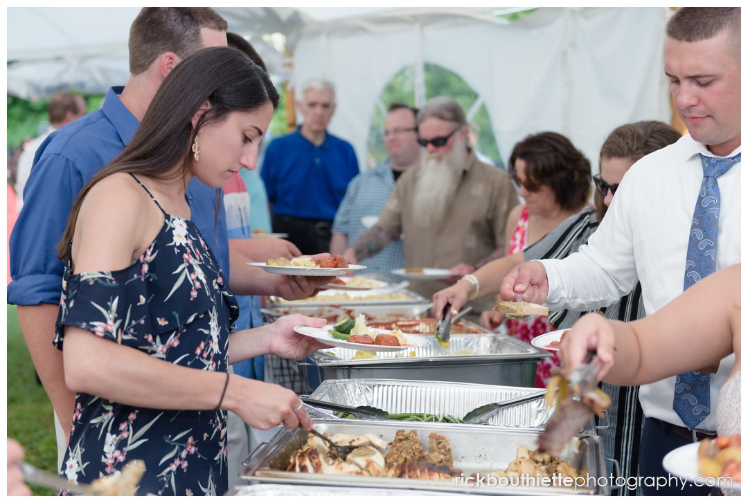 guests in buffet line at New Hampshire backyard summer wedding reception