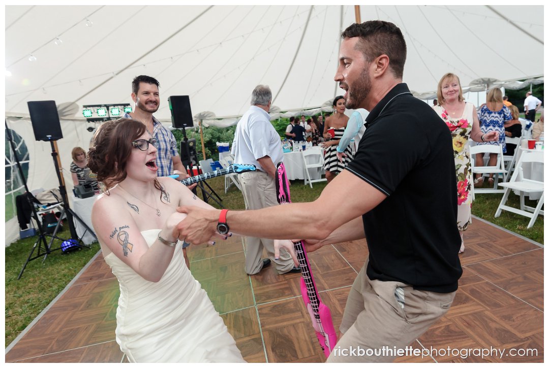 bride dancing with guests at her New Hampshire backyard summer wedding